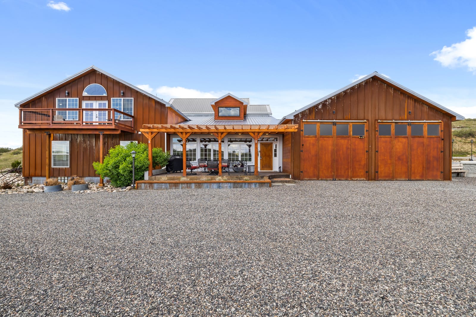 Cedar-sided main residence and adjoining garage building at the New Frontier Recovery Center property in Huntley, Montana